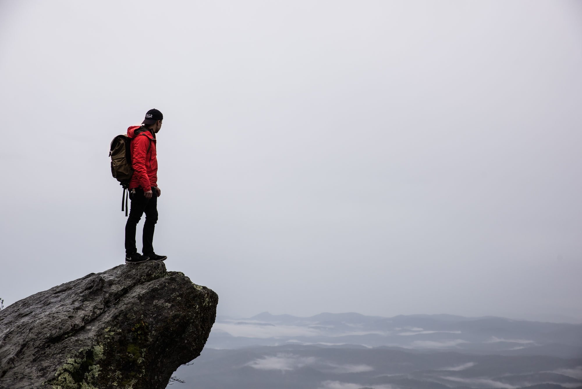 Man standing at the edge of a cliff